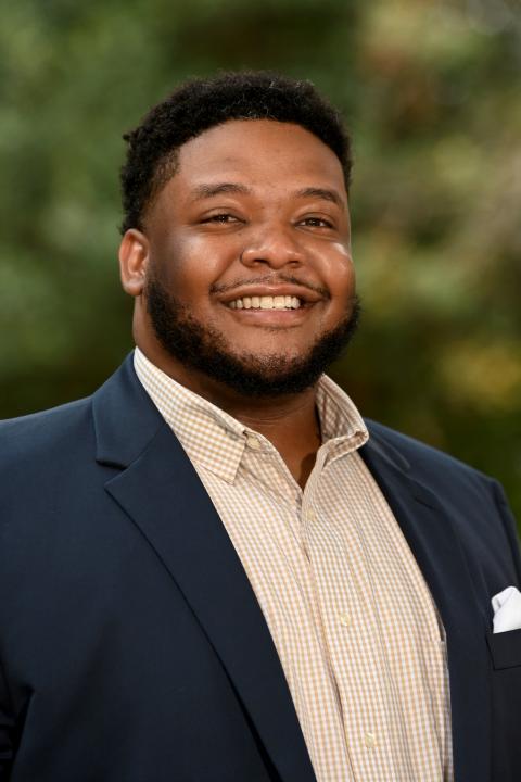 Chris Bridgers, headshot with collared shirt and blue sport coat. 