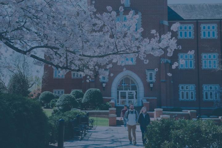 Students in front of UTC business building with spring flowers