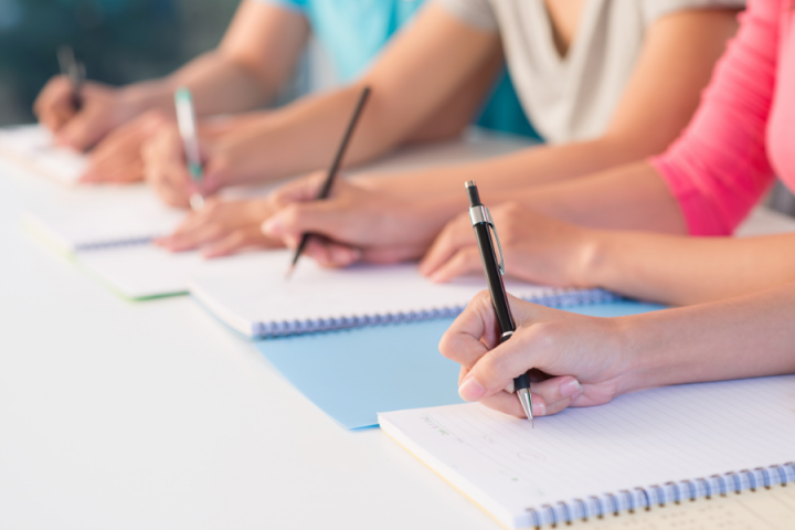 students writing in notebooks