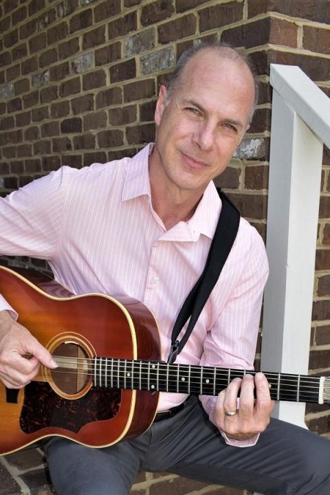 Stephen Brannen holding a guitar