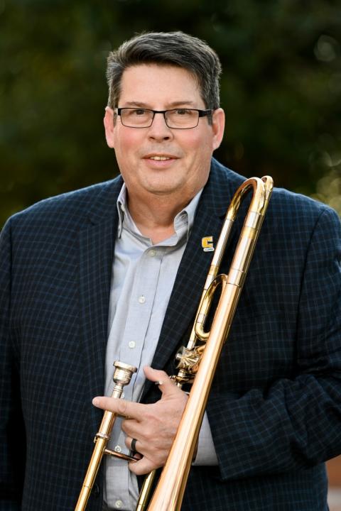Richard Stichler holding trombone