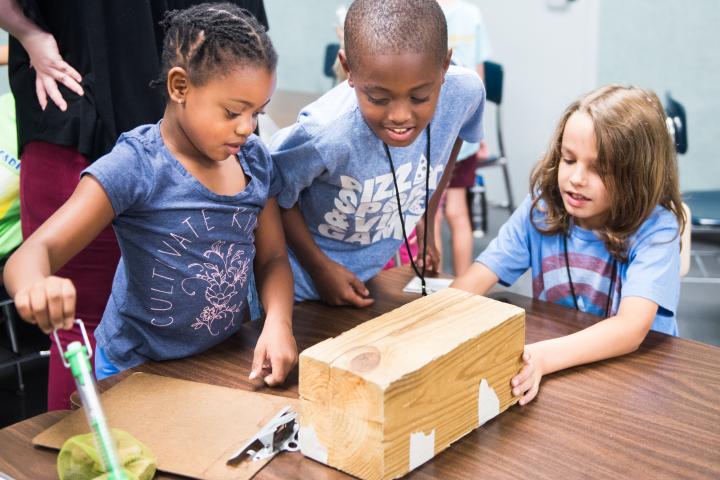 Three young learners enjoying a STEAM Learning Lab at the UTC Challenger Center