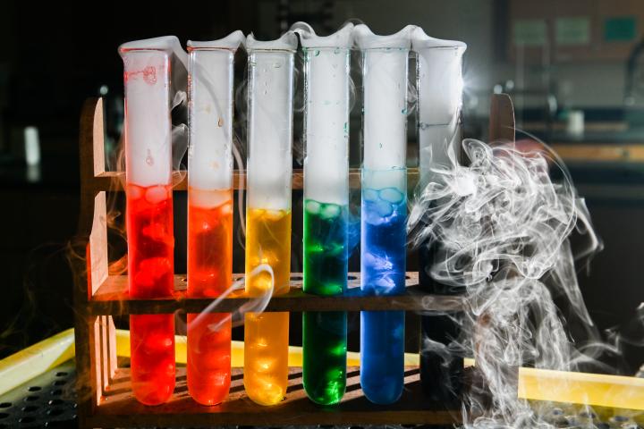 rainbow colored test tubes with smoke