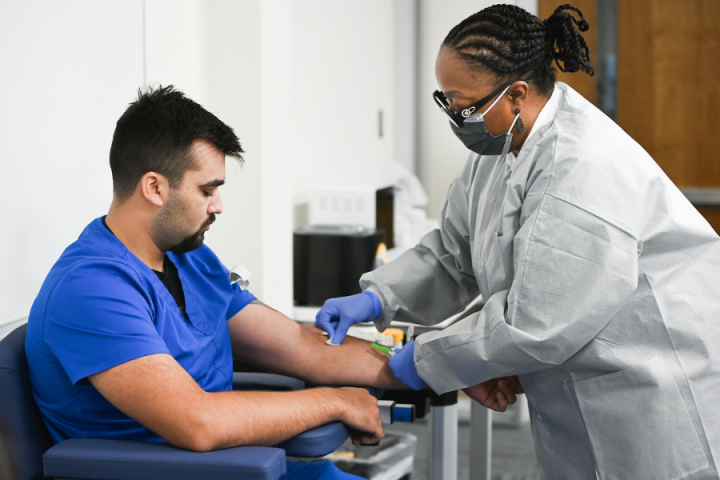 woman drawing blood of man