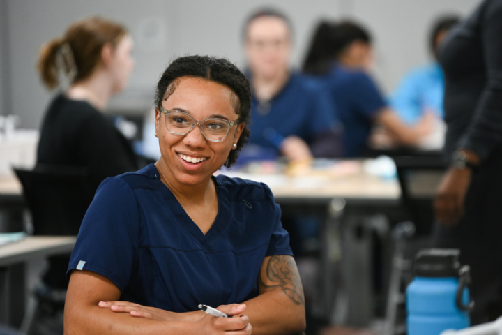 Phlebotomy Spring 22 woman smiling while taking class notes