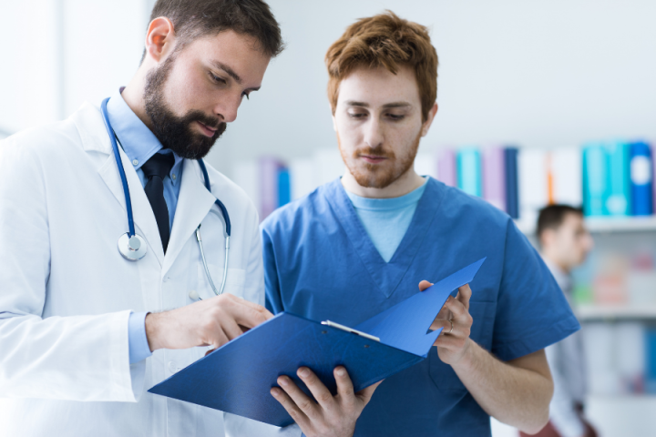 Clinical Medical Assistant male medical assistant speaking to doctor