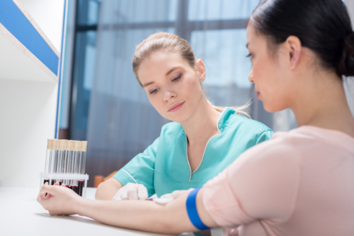 Clinical Medical Assistant female nurse taking blood