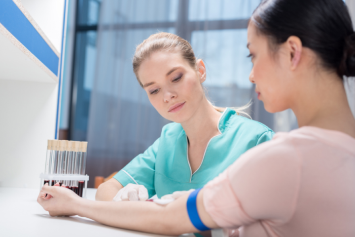 female nurse taking blood