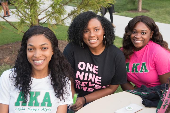 Three women pose for a group photo.