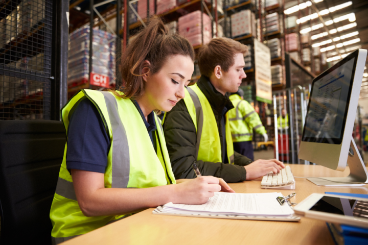 female and male logistics worker filling out paperwork female and male logistics worker filling out paperwork
