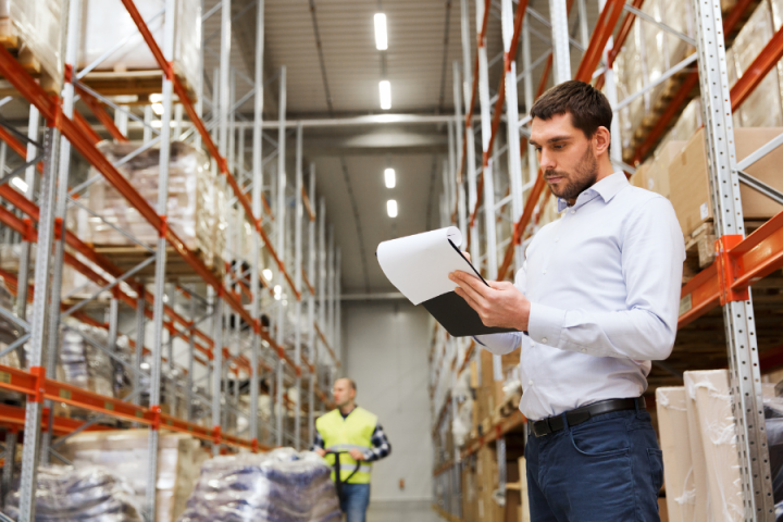 male logistics professional holding clipboard male logistics professional holding clipboard