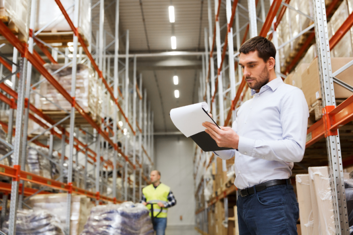 male logistics professional holding clipboard