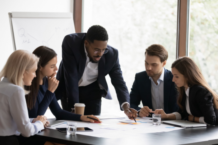 black male leading a group of project managers