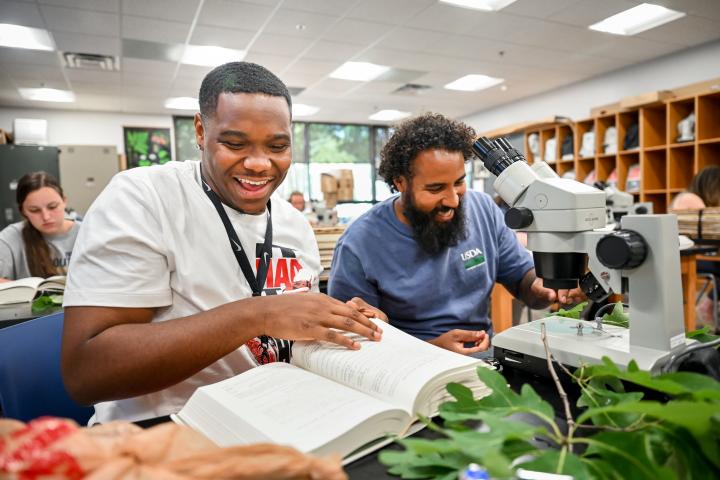 Students looking at a botany book