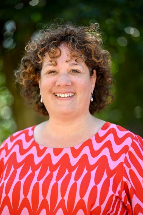 Female marketing strategist wearing a pink and red blouse