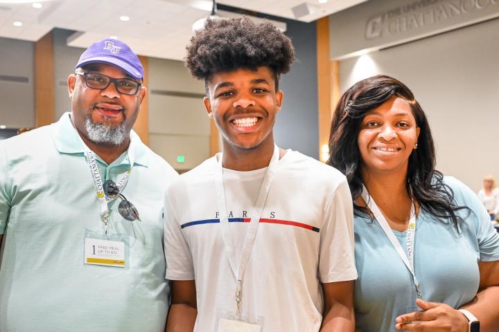 A family attending UTC orientation. Two guardians and one student visiting campus