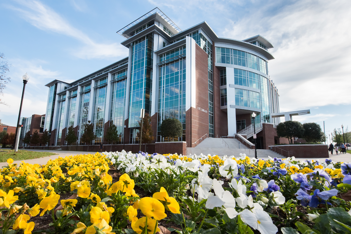 Photograph of the new UTC Library Building with a bed of brightly colored flower in the foreground.