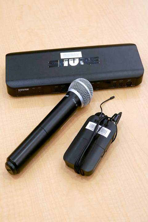 Photograph of one handheld and one lavalier microphone