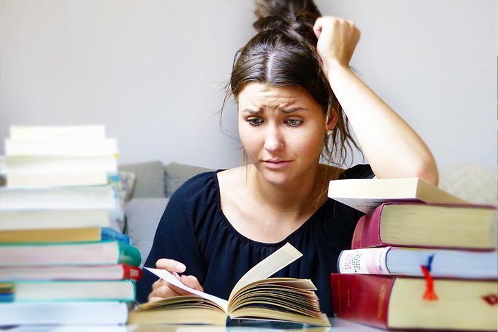 Photograph of a woman reading with a perplexed expression on her face.