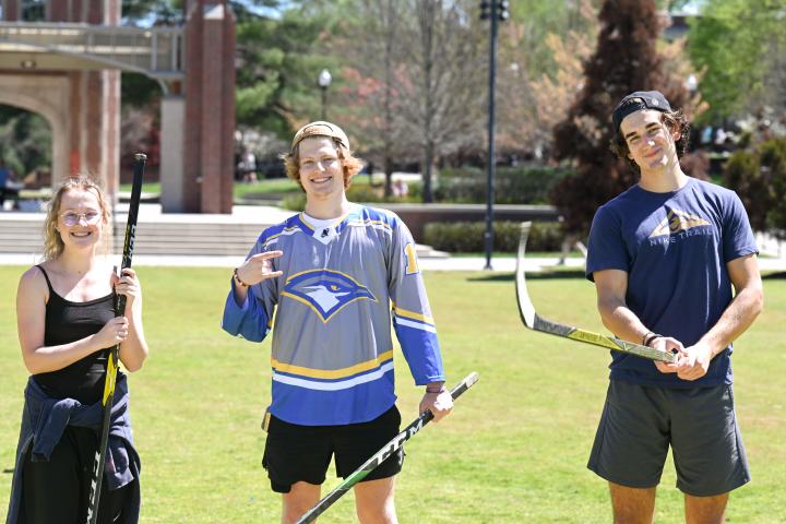 students playing hockey on Chamberlain field