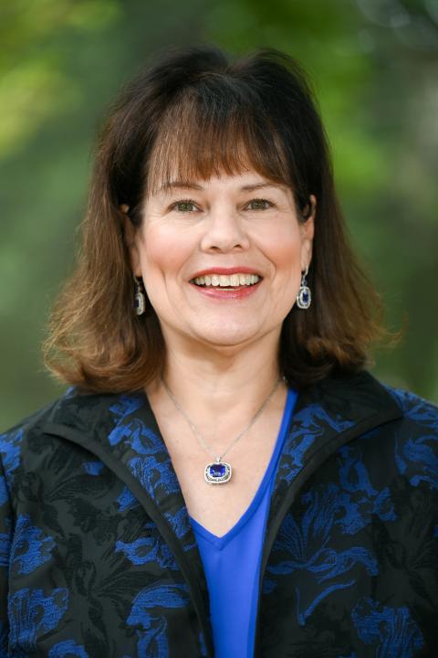 Profile photo of Katherine Karl in a royal blue shirt and jacket.