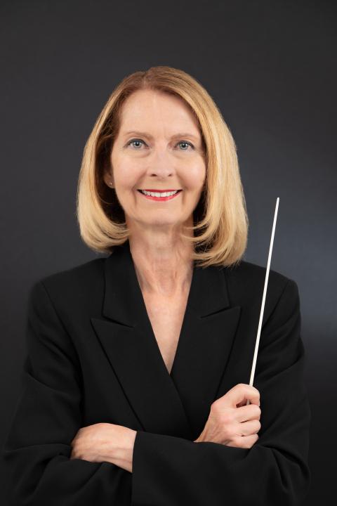 Sandy Moorris holding a conductor baton