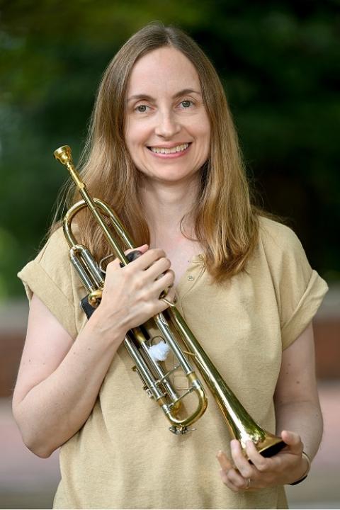 Photo of Erika Schafer smiling with her trumpet