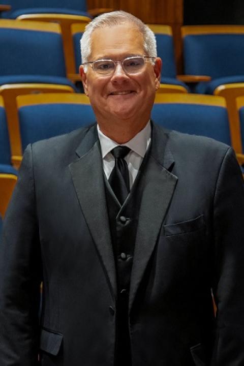 A headshot of Randall Coleman wearing a suit in the concert hall