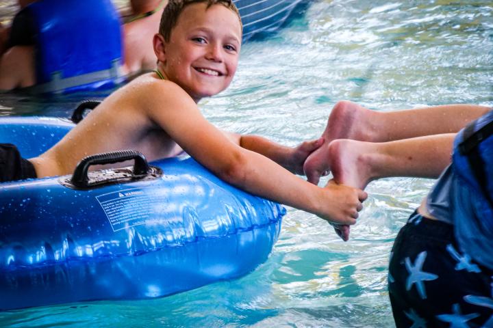 Mocs Adventure Camp - Camper Swimming In Tube - Summer 2023