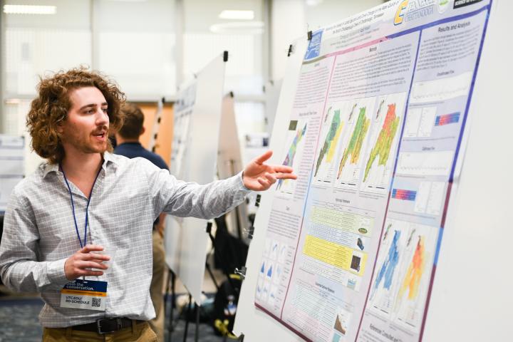 UTC Graduate Student Research UTC student pointing at his research chart