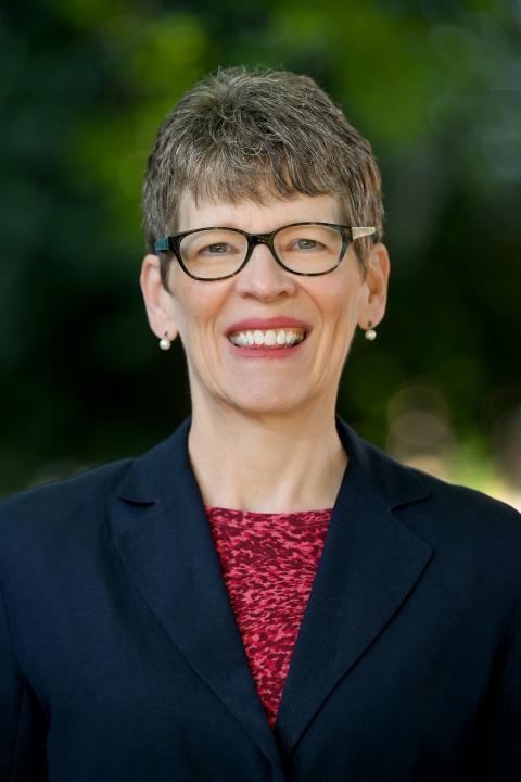 Profile photo of Dr. Lisa Burke-Smalley wearing a red blouse and navy blue jacket