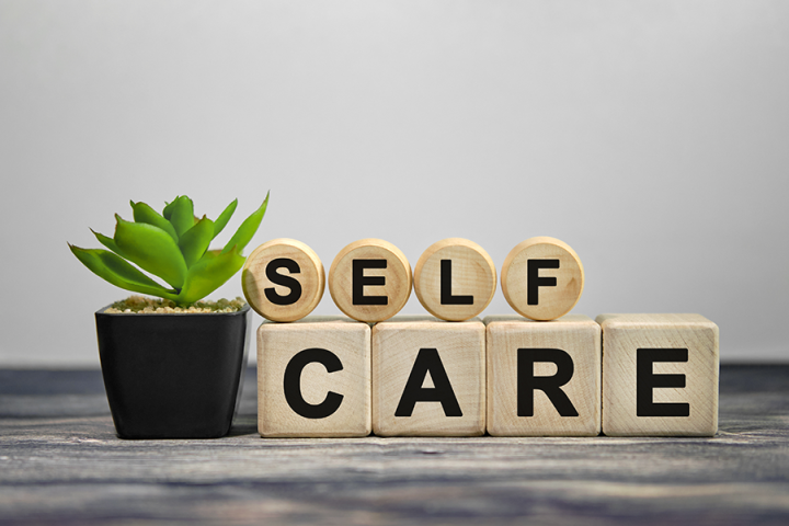 Photo of a green plant next to blocks which spell out "Self Care" Photo of a green plant next to blocks which spell out "Self Care"