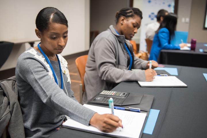 Business Students attend the College to Career Readiness Two students writing notes down