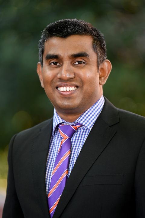 Profile image of Pubudu Jayasekara in a dark jacket, blue shirt and tie