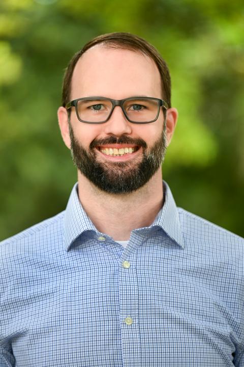 Employee Photo of Philip in front of a blurred green background