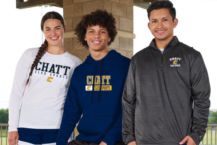 3 people standing in a picnic area wearing blue and gold Chatt attire. 