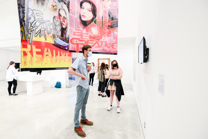 Assistant Professor Shane Ward (L) and exhibiting artist Emma Petrochko (Graphic Design, 2021), discuss her work in the 2021 BFA Senior Thesis Exhibition at the ICA