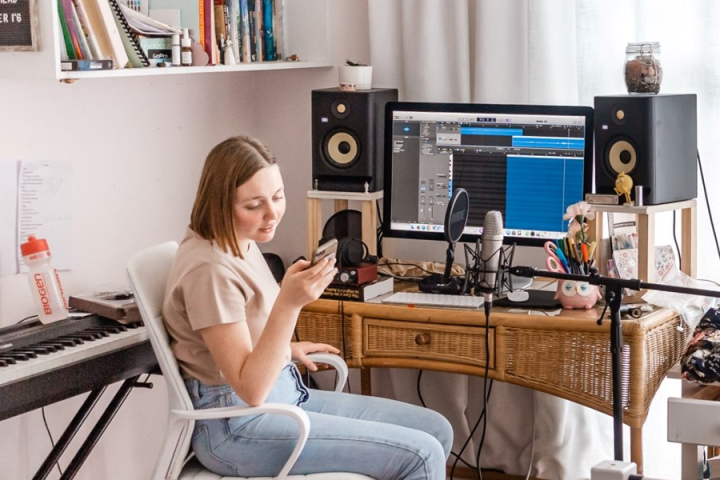 A woman edits music on her computer