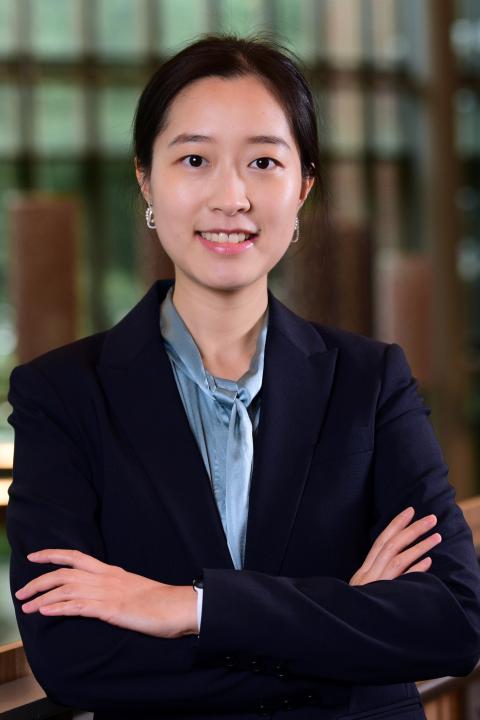 Profile image of Dan Luo wearing a navy jacket and light blue blouse.