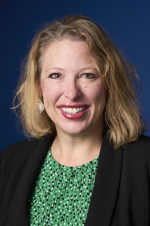 Jackie Morgan, Outreach Senior Adviser for the Federal Reserve Bank of Atlanta in a green shirt and black jacket