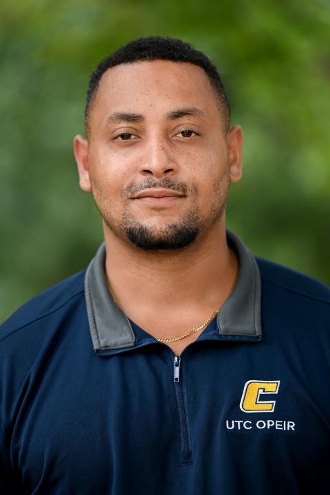 Headshot of man in blue shirt