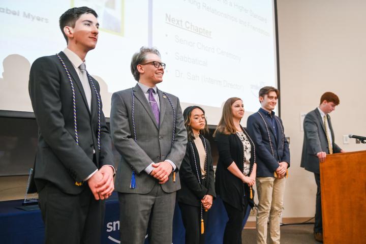 Students standing in class presenting for smile fund