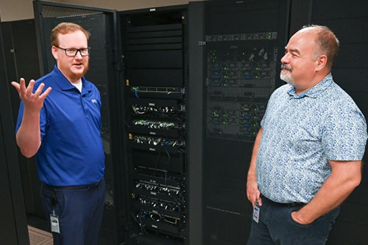 Computer Science - Data Science A photo of two men standing by a data center
