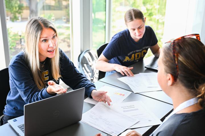 School of Education advisors speaking with students