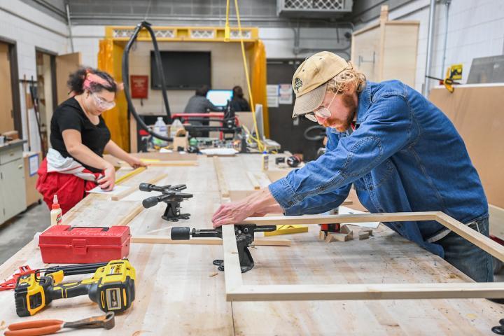 Two students build frames in the Fine Arts Center woodshop