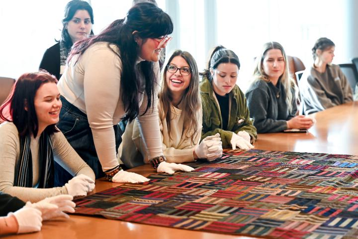 Art History students examine a quilt in UTC Special Collections