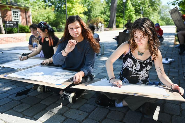 Foundations students work on drawings outside
