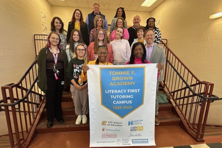 Literacy First group holding a banner