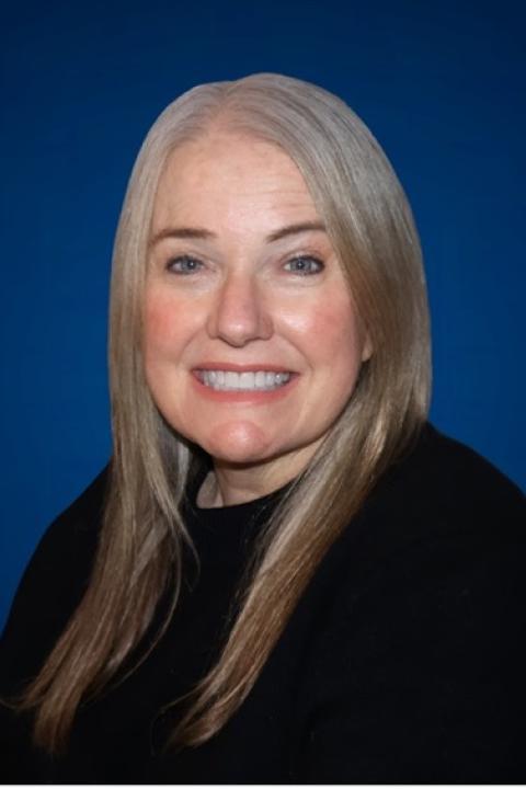 Headshot of Amy Moore in a black crewneck sweater.