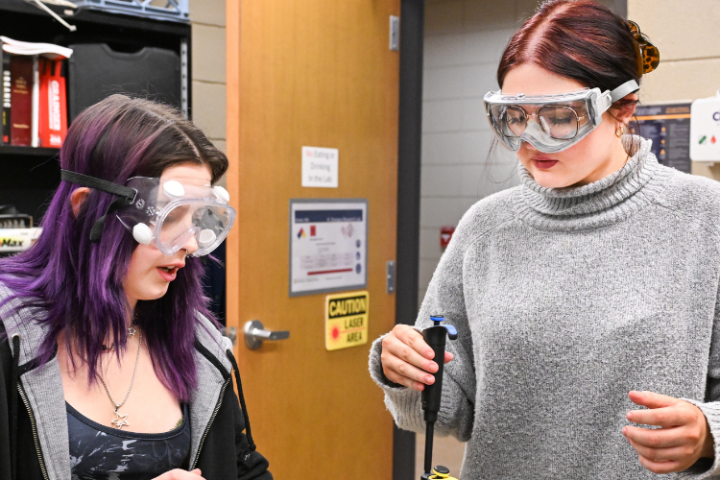 Two students performing a chemistry experiment